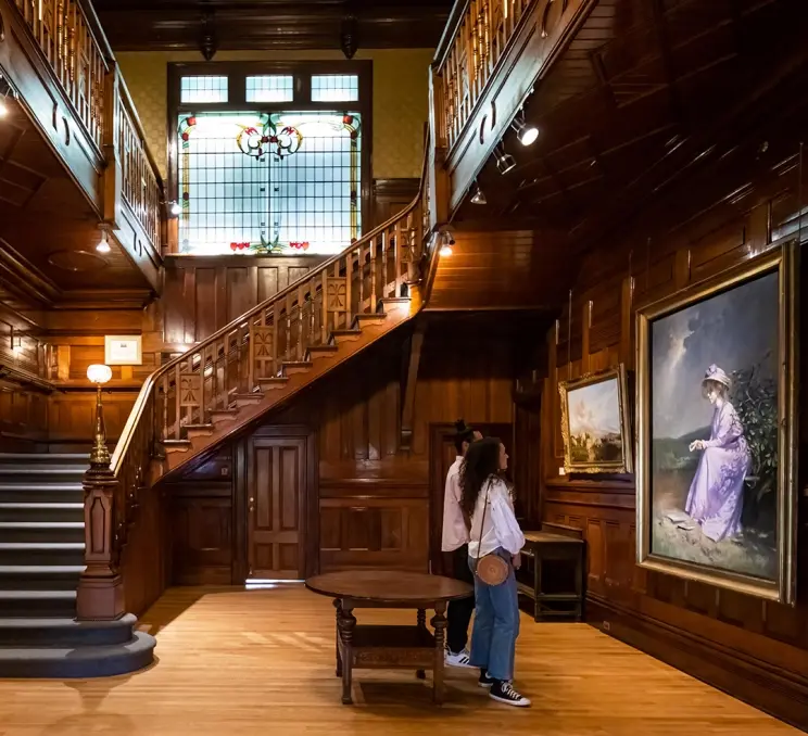 A couple admires the artwork inside the heritage home wing of the Art Gallery of Greater Victoria in Victoria, BC
