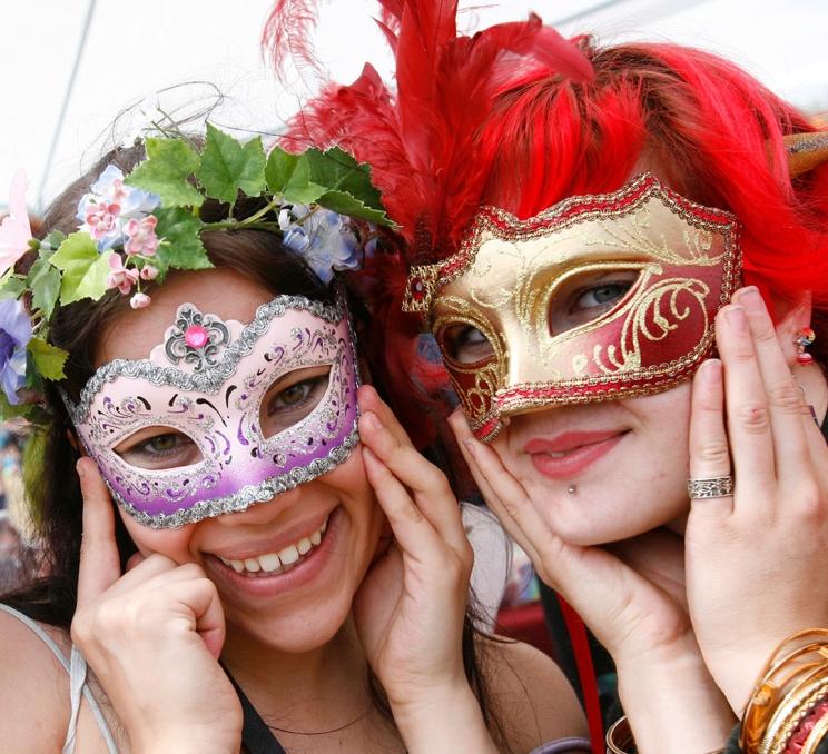 Two friends in masks pose for a photo at the Victoria Pride Parade in Victoria, BC