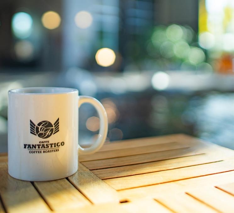 A cup of coffee rests on a table at Caffe Fantastico in Victoria, BC