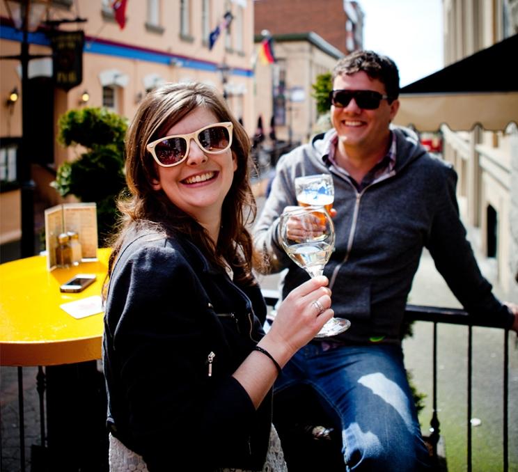 A couple smiles on the patio at the Irish Times in Victoria, BC