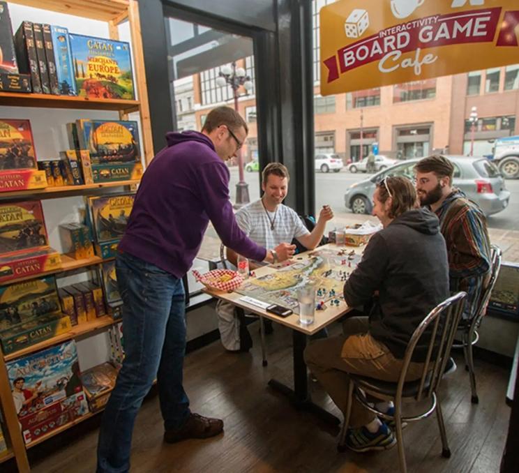 A group of friends play board games at Interactivity Board Game Cafe in Victoria, BC