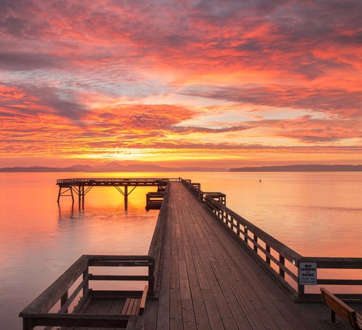 The Sidney Pier stretches off into the sunrise in Victoria, BC