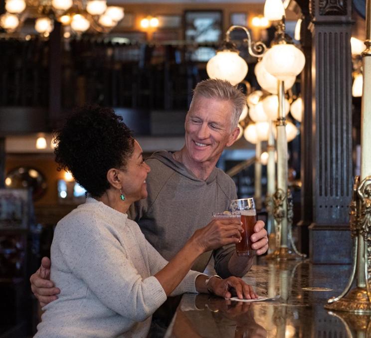 A couple enjoys a drink at the Bard & Banker in Victoria, BC