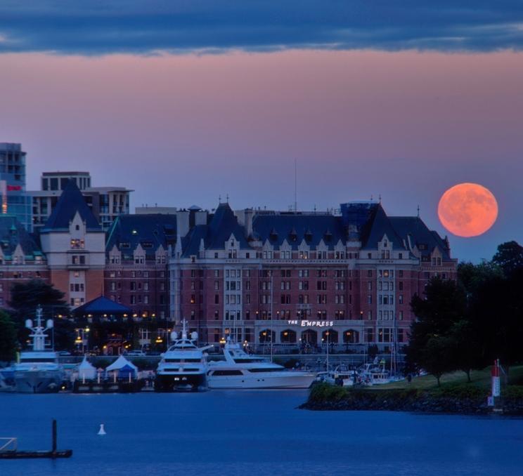 A full moon rises behind the Fairmont Empress in Victoria, BC