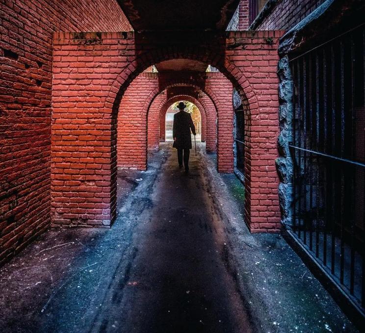 A man walks through Helmcken Alley in Victoria, BC