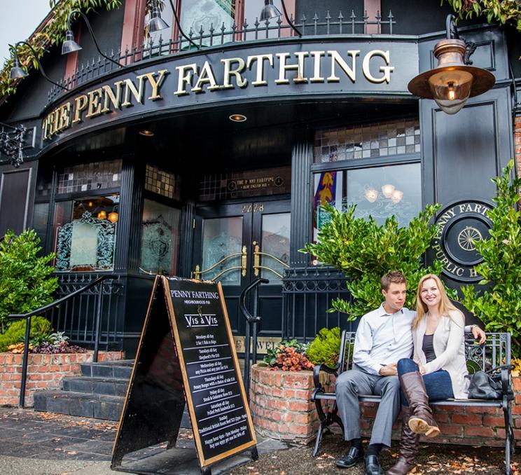 A couple sits outside the Penny Farthing in the Oak Bay Neighbourhood of Greater Victoria, BC