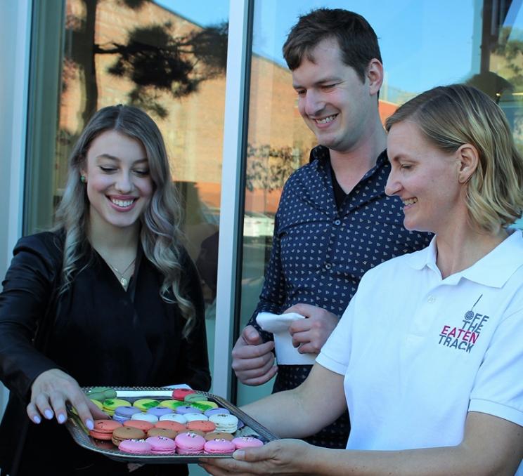 A couple tries some macarons during an Off the Eaten Track food tour in Victoria, BC