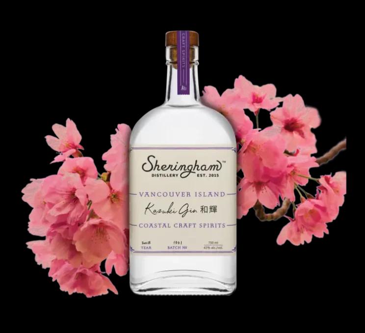 A bottle of gin from Sheringham Distillery set amidst cherry blossoms in Victoria, BC