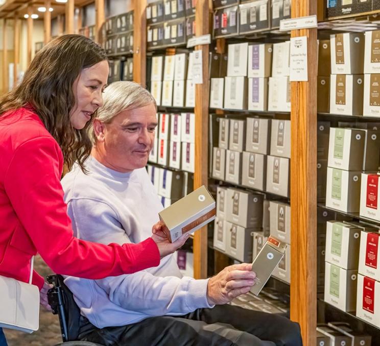 A couple explores the selection of tea at Murchie's Tea & Coffee in Victoria, BC