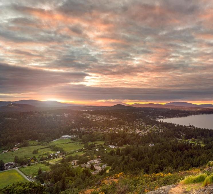 A view of the Saanich Peninsula at sunset from PKOLS - Mount Douglas regional park in Victoria, BC