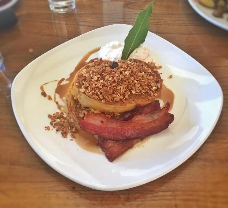 A plate of pancakes and bacon at OEB Breakfast Co. in Victoria, BC