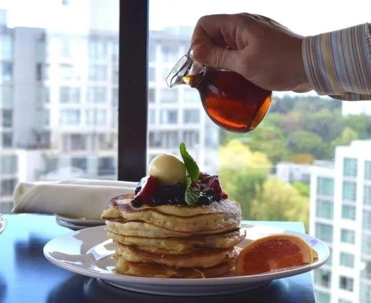 Pancake piled high window-side at Vista 18 Restaurant + Lounge in Victoria, BC