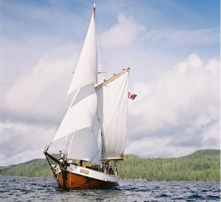 A yacht from 3-Hour Sail sails across the Salish Sea off the coast of Victoria, BC