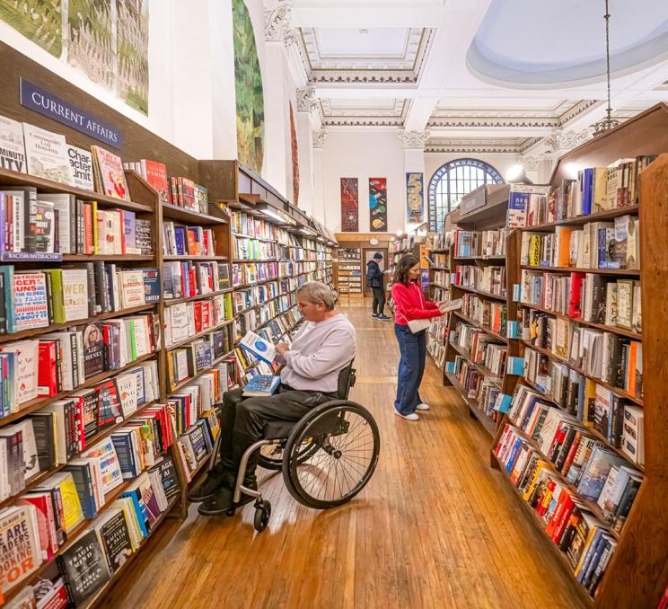 A couple shops for books inside Munro's Books, a bookstore in Victoria, BC