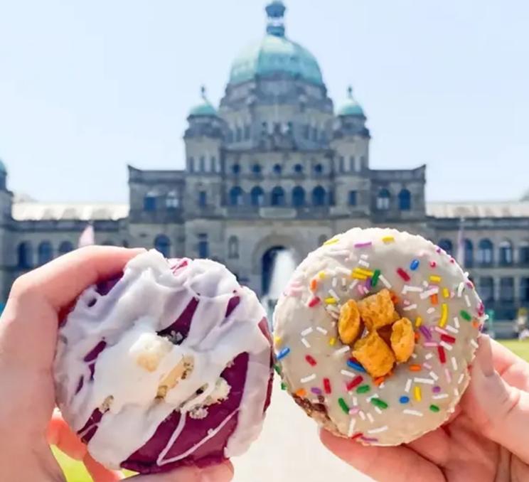 A pair of donuts in front of the BC Parliament Buildings during an Underground Donut Tour in Victoria, BC