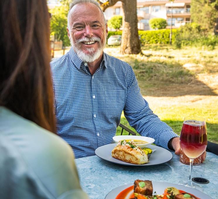 A couple dines on the patio at Fireside Grill in Victoria, BC