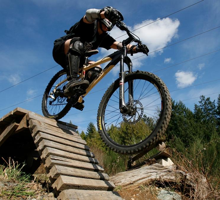 A mountain biker does a drop in at Mount Work Regional Park in Victoria, BC