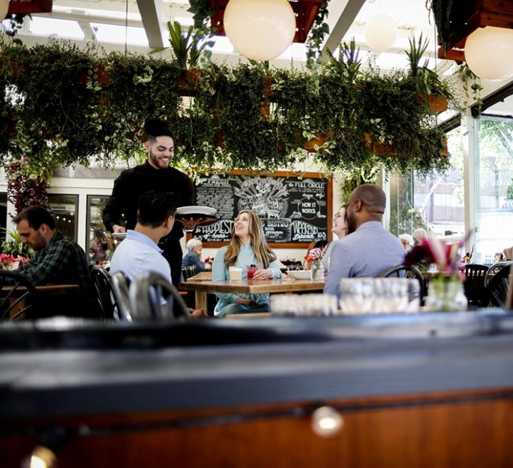 A group dines at 10 Acres in Victoria, BC