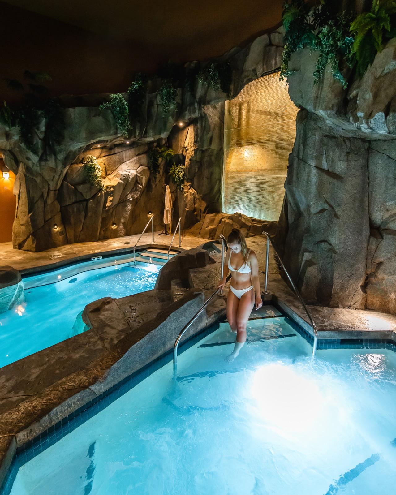 Girl going into Grotto Spa whirlpool from the mineral pool.