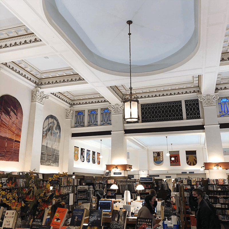 Shelves of Books and Beautiful Artwork Inside Munro's Books Heritage Building