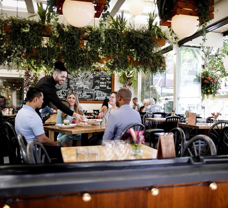 A group of friends dine together at 10 Acres Bistro in Victoria, BC