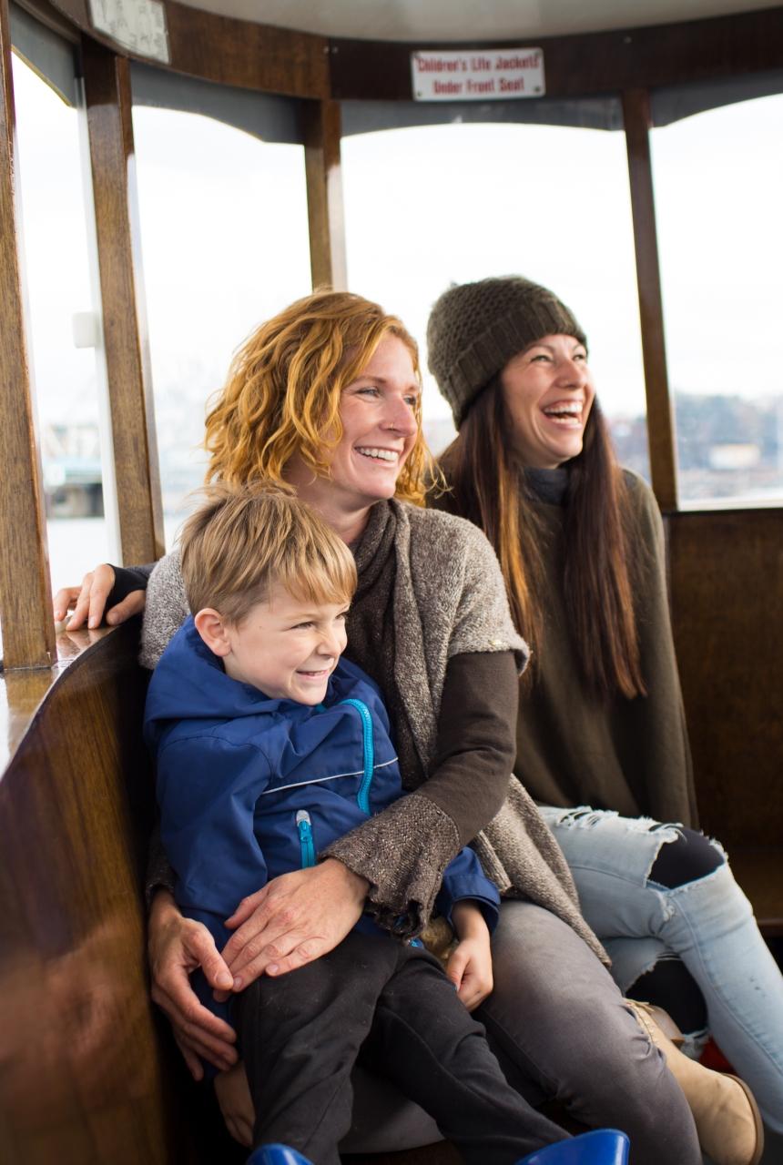 A family enjoying a Harbour Ferry ride around the inner harbour in Victoria, BC