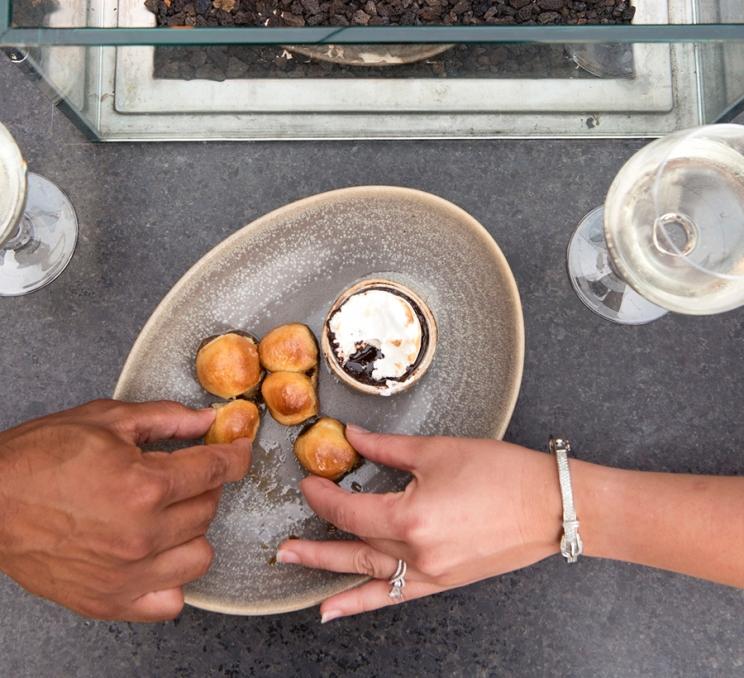 A couple shares a dessert at LURE Restaurant & Bar in Victoria, BC