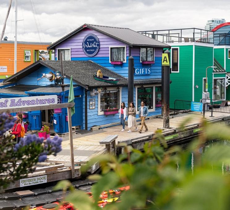 A family walks along the docks at Fisherman's Wharf in Victoria, BC