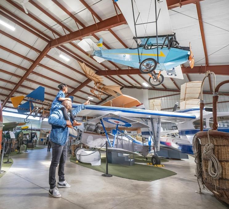 A father and daughter look at the aircraft on display at the BC Aviation Museum in Victoria, BC