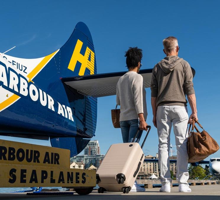 A couple disembarks from a Harbour Air Seaplane in Victoria, BC