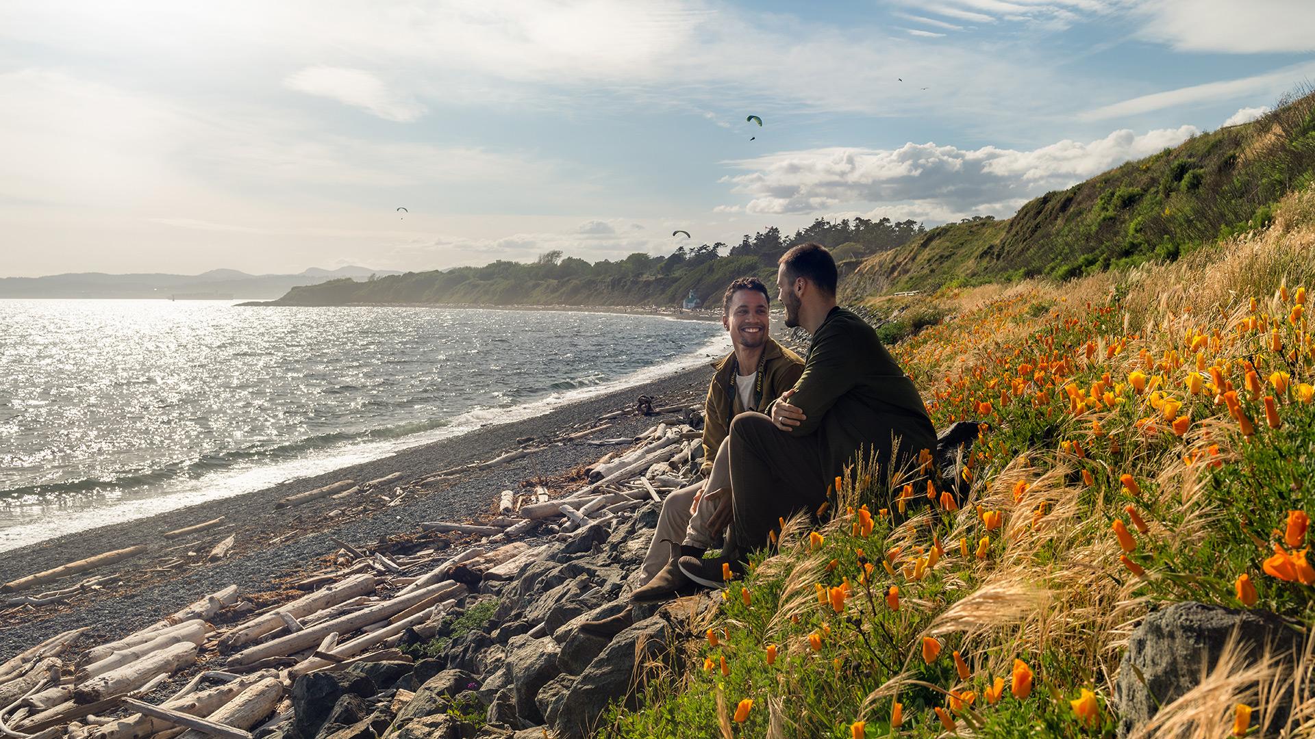 Couple enjoys the views from the beach at Cattle Point, Victoria, BC