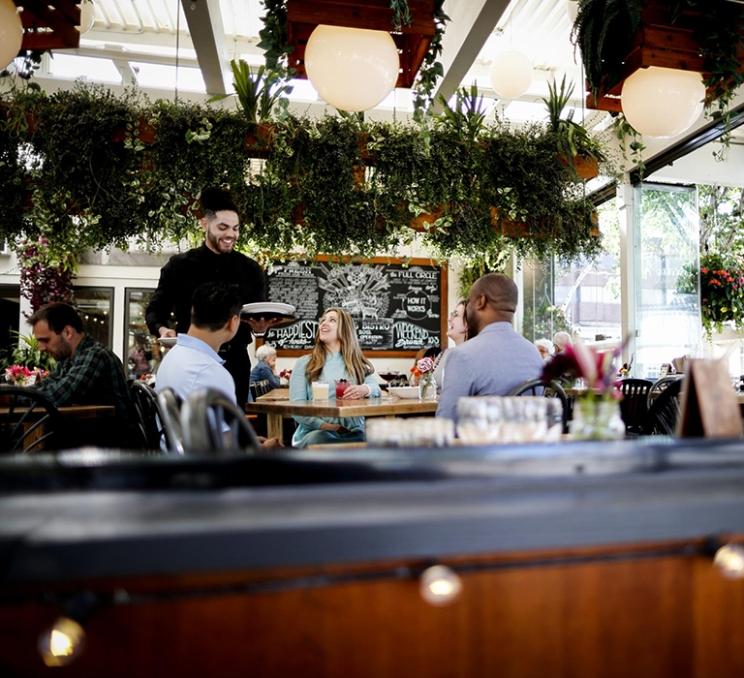 A group is served at 10 Acres Bistro in Victoria, BC