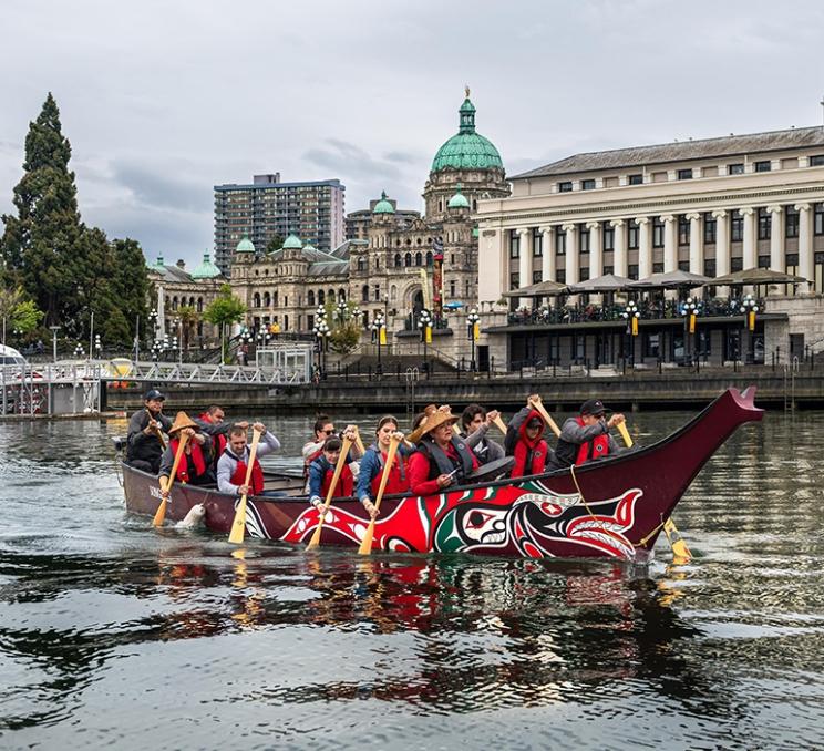 A canoe tour paddles through the Inner Harbour in Victoria, BC