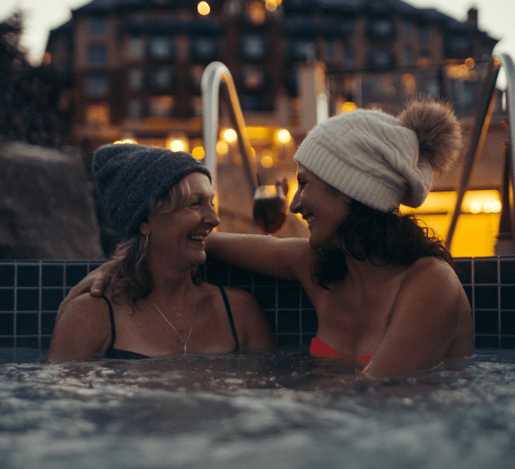 A couple soaks in a hot tub at the Oak Bay Beach Hotel in Victoria, BC