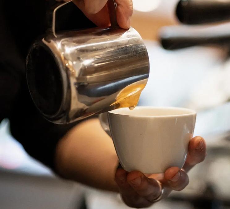 A latte is prepared at Fernwood Coffee in Victoria, BC