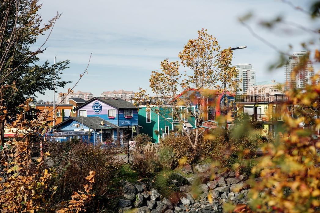 A view through the trees towards Fisherman's Wharf in Victoria, BC