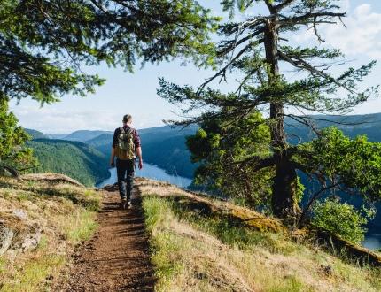 A man walks a trail in Gowlland Tod Provincial Park in Victoria, BC