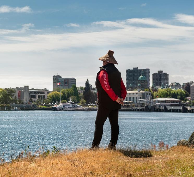 An Lekwungen woman looks out over Victoria's Inner Harbour