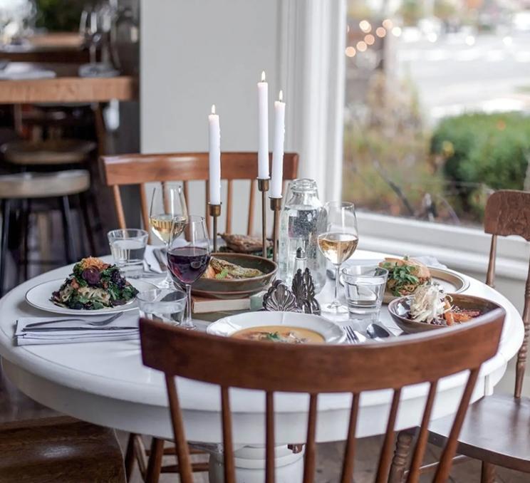 A set table full of fall food at Nourish Kitchen & Cafe in Victoria, BC