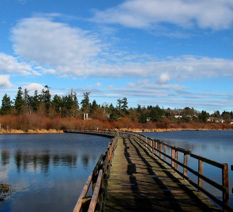 A bridge crosses the water at Swan Lake Nature Sanctuary in Victoria, BC