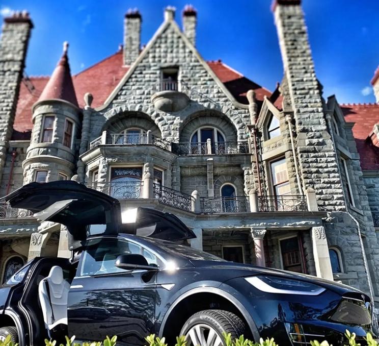 A Tesla outside of Craigdarroch Castle in Victoria, BC