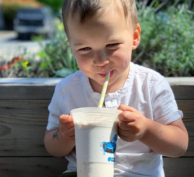 A young child enjoys a milkshake at Big Wheel Burger in Victoria, BC