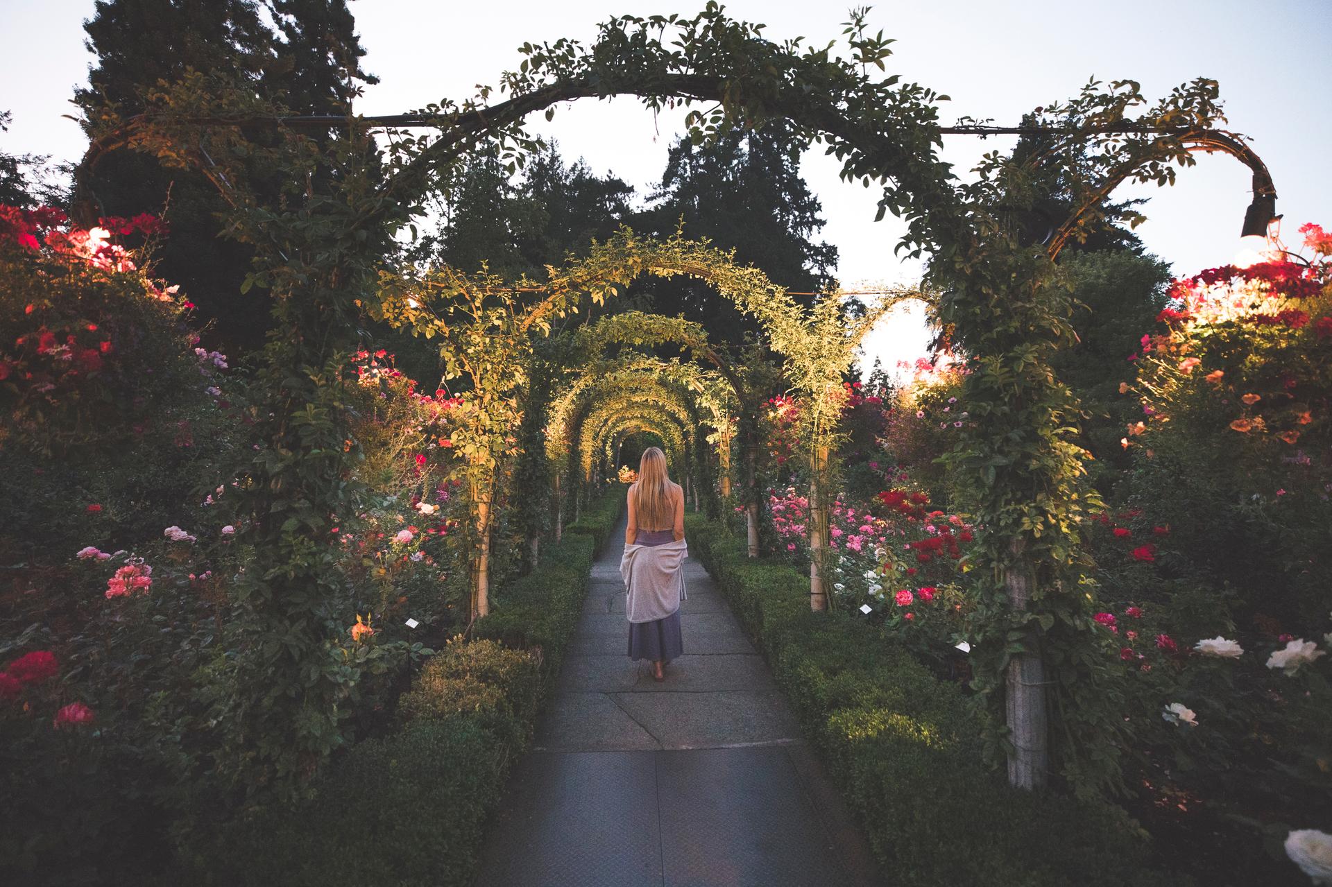 A woman walks along a pathway at The Butchart Gardens in Victoria, BC