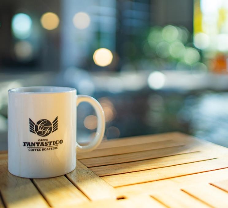 A coffee cup on a table at Caffe Fantastico in Victoria, BC