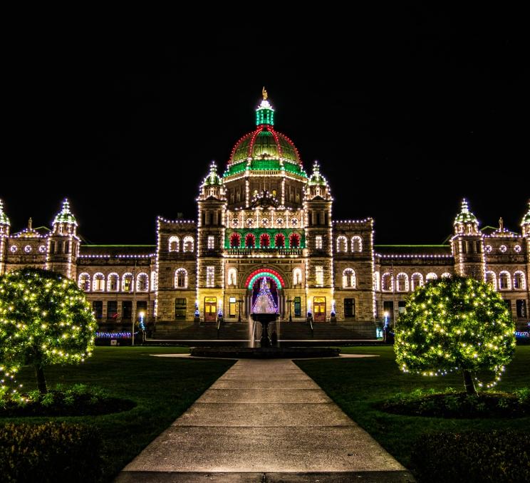 The BC Parliament Buildings illuminated at night in Victoria, BC