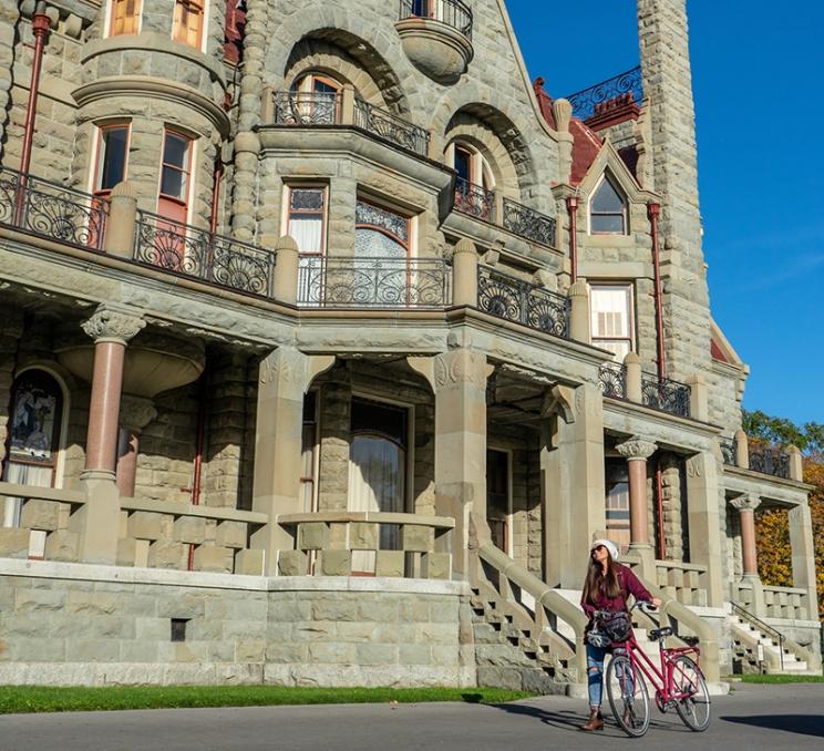 A cyclist arrives at Craigdarroch Castle in Victoria, BC