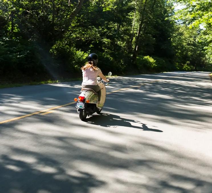 A scooter rented from CycleBC takes a ride along a road in Victoria, BC