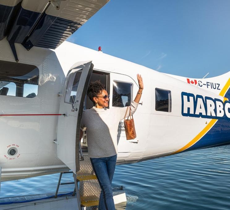 A woman disembarks a Harbour Air Seaplane in Victoria's Inner Harbour