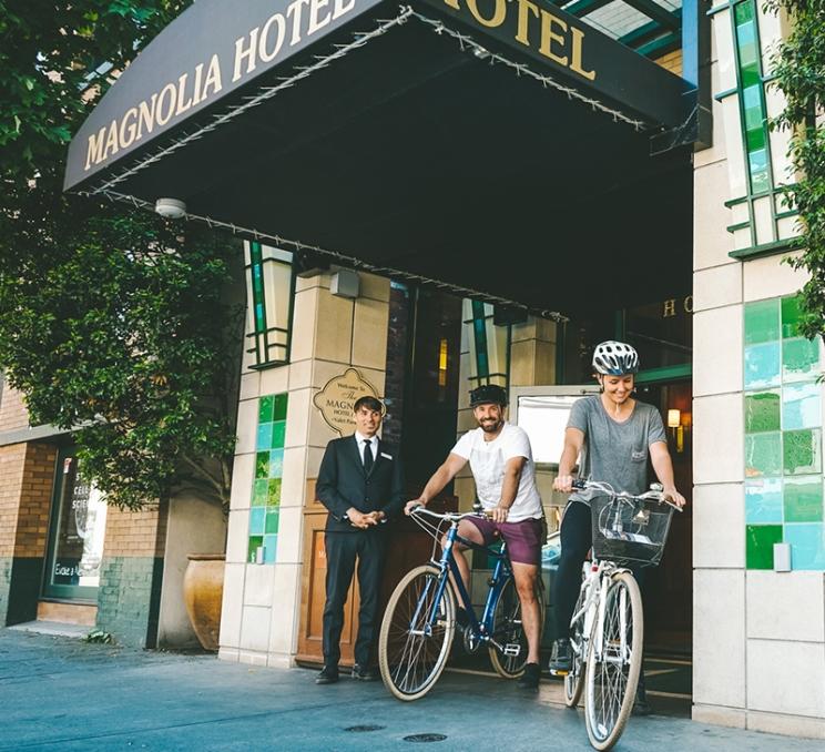 A couple sets off on a bike riding trip from the Magnolia Hotel & Spa in Victoria, BC