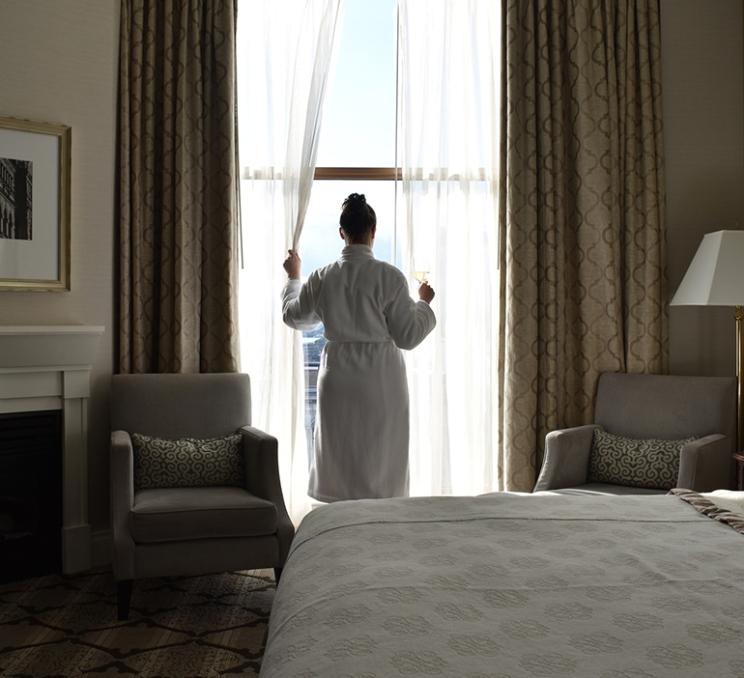 A woman enjoys a glass of wine at the Magnolia Hotel & Spa in Victoria, BC